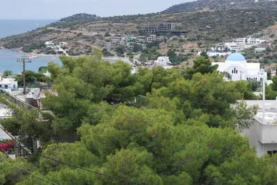 a view of a town with trees and a hill at Sunset Rooms in Agia Marina Aegina