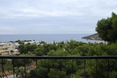a view of the ocean from a balcony at Sunset Rooms in Agia Marina Aegina
