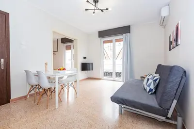 a living room with a table and a chair at Psirri Place economy apartments centrally located in Athens