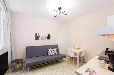 a living room with a couch and a table at Psirri Place economy apartments centrally located in Athens