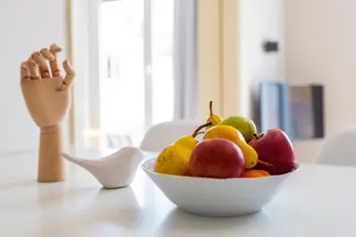 a bowl of fruit sitting on a table at Psirri Place economy apartments centrally located in Athens