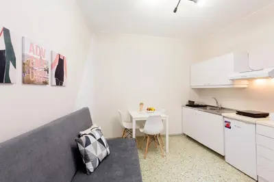 a living room with a couch and a table at Psirri Place economy apartments centrally located in Athens