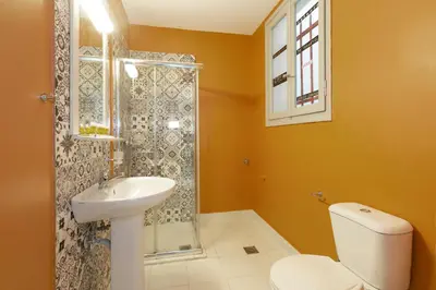 a bathroom with a toilet and a sink and a shower at Psirri Place economy apartments centrally located in Athens