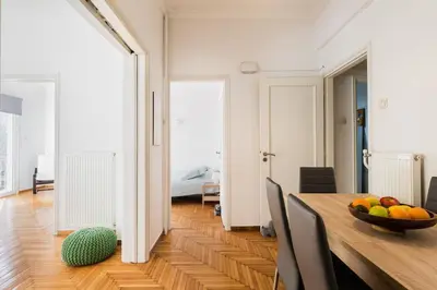 a room with a table with a bowl of fruit on it at Central 5 Room Apartment in Athens