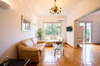 a living room with a couch and a table at Central 5 Room Apartment in Athens