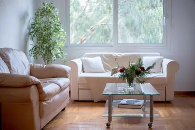 a living room with a couch and a table at Central 5 Room Apartment in Athens