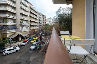 a balcony with a table and a view of a city at Central 5 Room Apartment in Athens