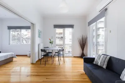 a living room with a couch and a table with chairs at Central 5 Room Apartment in Athens