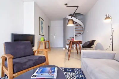 a living room with a couch and a chair at Central Apartment in Athens