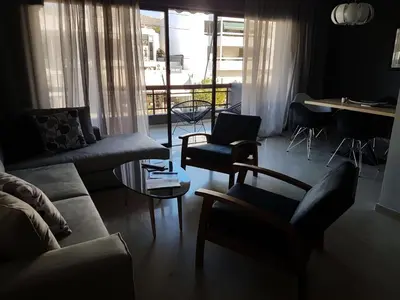 a living room with a couch and chairs and a table at Central Apartment in Athens