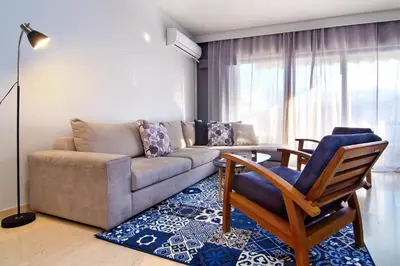 a living room with a couch and a table at Central Apartment in Athens
