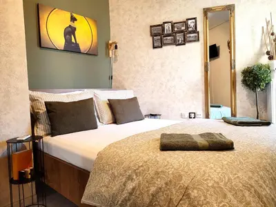 a bedroom with a large bed with a mirror at Elia Apartments in Athens