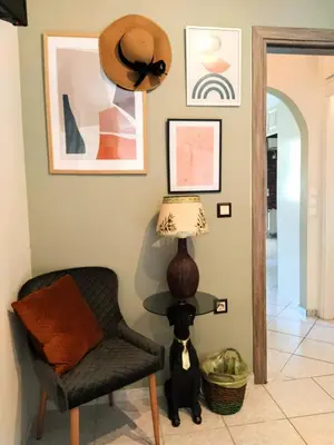 a room with a chair and a hat on the wall at Elia Apartments in Athens