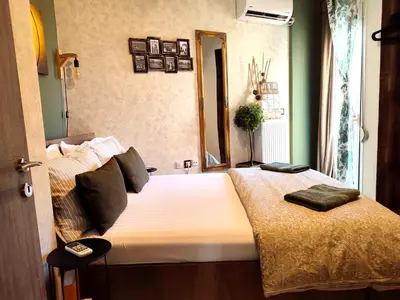 a bedroom with a bed with a mirror on it at Elia Apartments in Athens