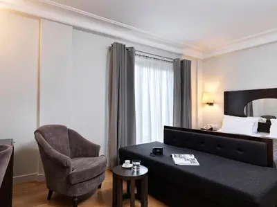 a hotel room with a couch and a chair and a bed at Acropolis Hill Hotel in Athens