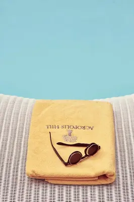 a pair of sunglasses sitting on top of a towel at Acropolis Hill Hotel in Athens