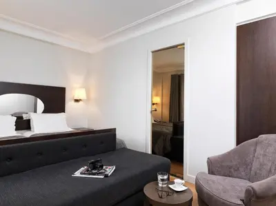 a hotel room with a bed and a chair at Acropolis Hill Hotel in Athens
