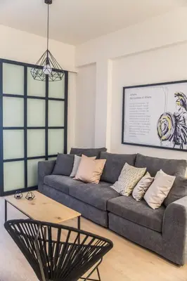 a living room with a couch and a table at Olympus Residence in Athens