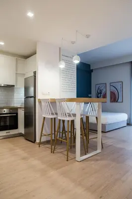 a kitchen and dining room with a table and chairs at Olympus Residence in Athens