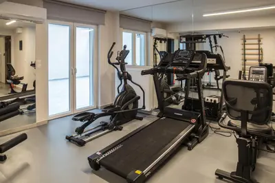 a gym with treadmills and elliptical machines at Olympus Residence in Athens