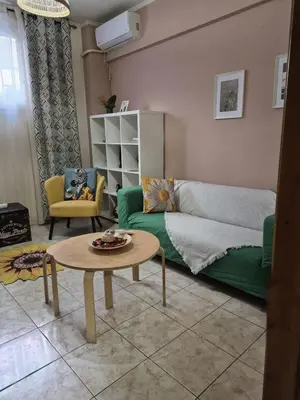 a living room with a green couch and a table at •Budget travellers •Great location in Athens