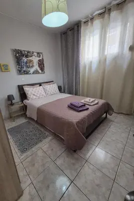 a bedroom with a bed and a large window at •Budget travellers •Great location in Athens