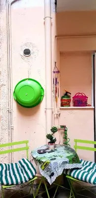 a table with a green frisbee hanging on a wall at •Budget travellers •Great location in Athens