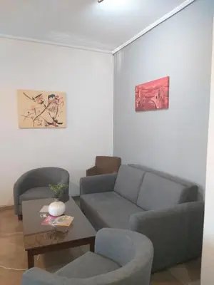 a living room with a couch and two chairs at Apollo Hotel in Athens