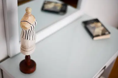 a wooden figurine on a white table at Athens Squared Apartments in Athens
