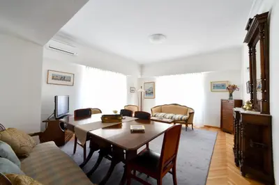 a living room with a table and a couch at Athens Squared Apartments in Athens