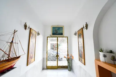 a hallway with a door and paintings on the wall at Athens Squared Apartments in Athens
