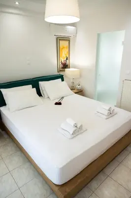 a large white bed with two towels on it at Keratea Luxury Villa -Athens Airport in Keratea