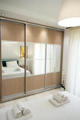 a bedroom with a large mirror and a bed at Keratea Luxury Villa -Athens Airport in Keratea