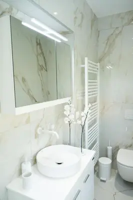 a white bathroom with a sink and a mirror at Keratea Luxury Villa -Athens Airport in Keratea
