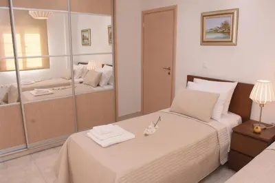 a bedroom with a bed and a large mirror at Keratea Luxury Villa -Athens Airport in Keratea