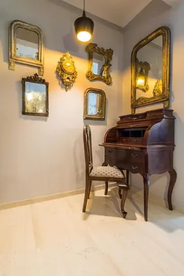 a room with a piano and a chair and mirrors at Comfortable and Spacious 2 bdr Apt in Athens