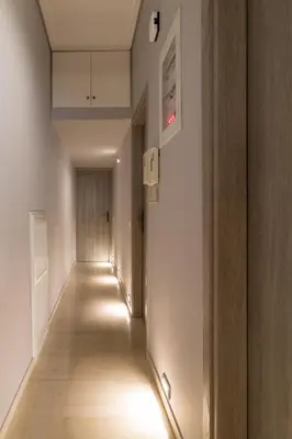 an empty hallway with lights on the walls at Comfortable and Spacious 2 bdr Apt in Athens
