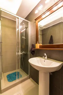 a bathroom with a sink and a shower at Comfortable and Spacious 2 bdr Apt in Athens