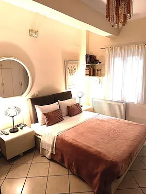 a bedroom with a large bed and a mirror at Casa Elisabetta in Athens