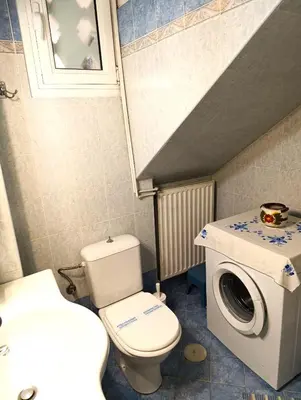 a bathroom with a toilet and a washing machine at Casa Elisabetta in Athens
