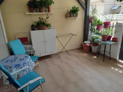 a room with chairs and a cabinet with potted plants at Casa Elisabetta in Athens