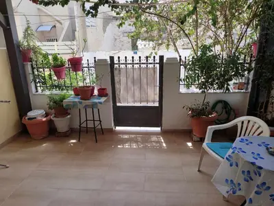 a patio with a black door and potted plants at Casa Elisabetta in Athens