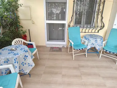 a patio with blue chairs and tables and a window at Casa Elisabetta in Athens