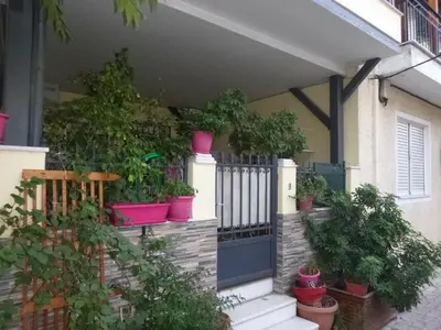 a porch with potted plants and a blue door at Casa Elisabetta in Athens