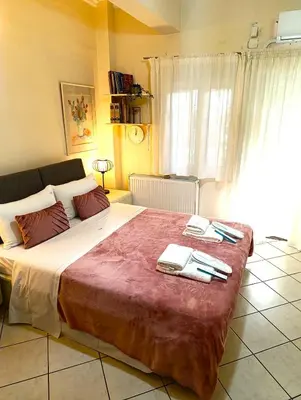 a bedroom with a large bed with towels on it at Casa Elisabetta in Athens