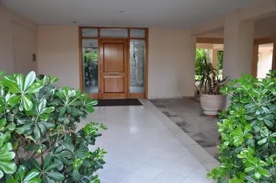 a lobby with a wooden door and some plants at Seaside Apartment 157 м2 in Athens