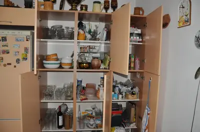 a kitchen cabinet filled with lots of food at Seaside Apartment 157 м2 in Athens