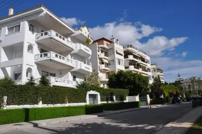 a white building on the side of a street at Seaside Apartment 157 м2 in Athens