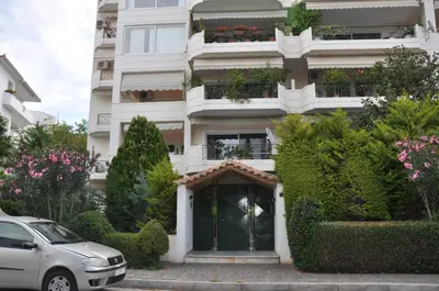 a white building with a door in front of it at Seaside Apartment 157 м2 in Athens