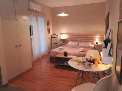 a bedroom with a bed and a table and chairs at Koukaki ideal studio for 2 in Athens